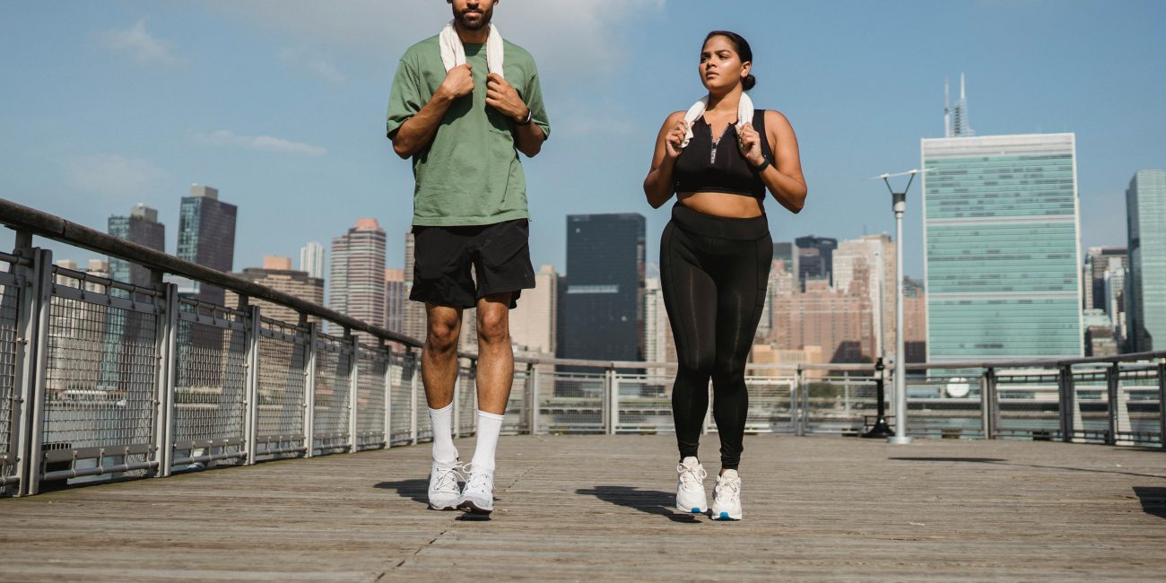 Two people walking to a gym class